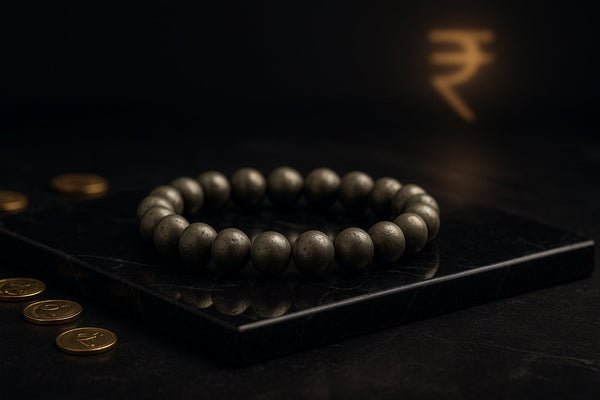 Luxury 8mm Natural Pyrite Bracelet for Wealth and Prosperity on black marble with gold rupee coins – Nazima Agate